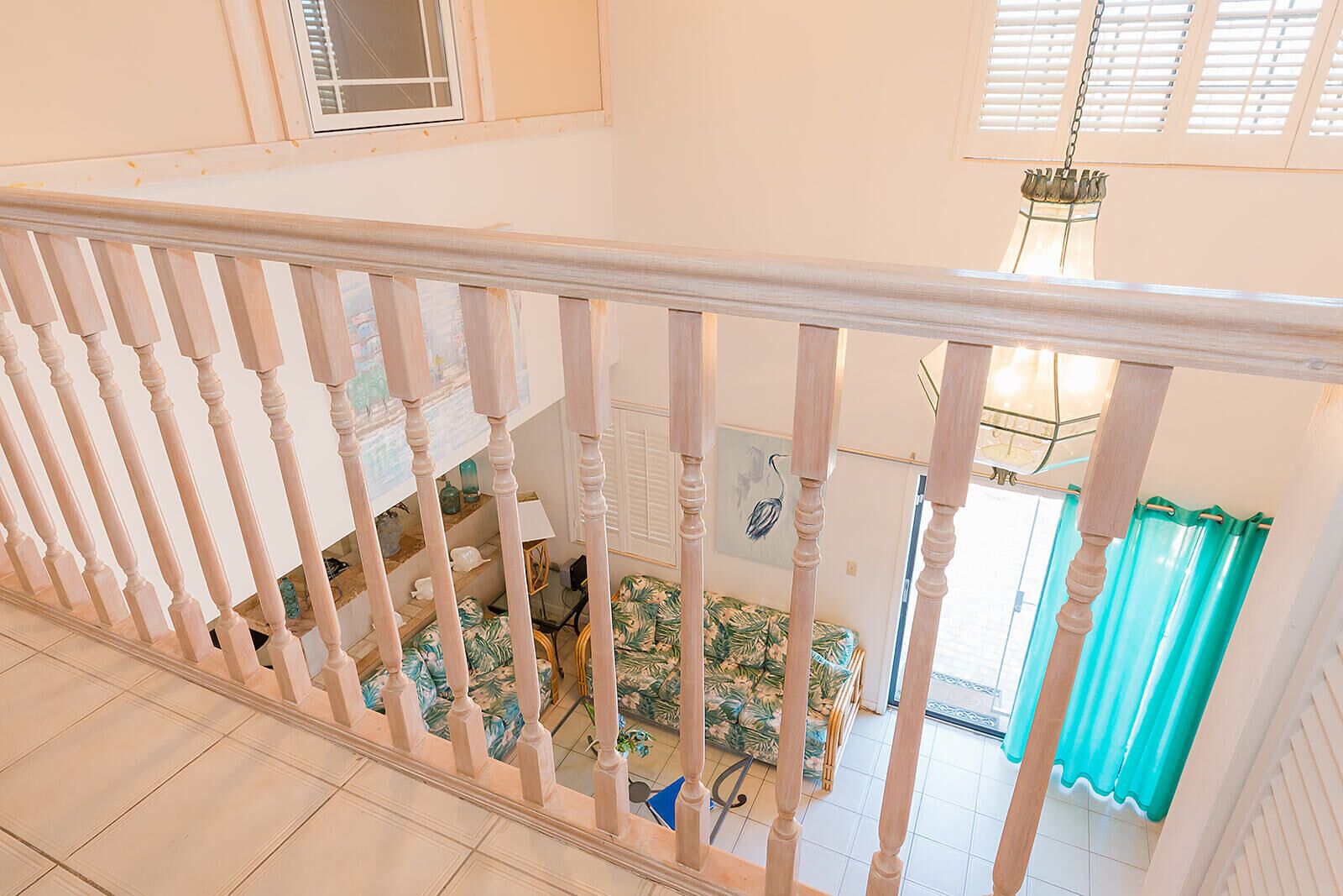 A staircase with a white balustrade leading to a lower level.