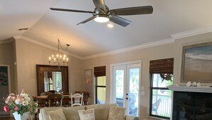 A spacious living room with a large sectional sofa, a coffee table, and a fireplace.