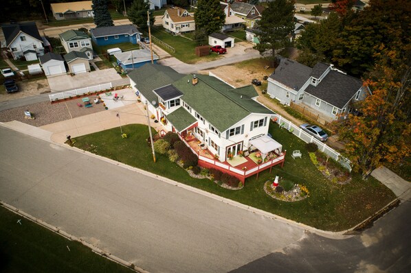A residential area with houses, a driveway, and a lawn.