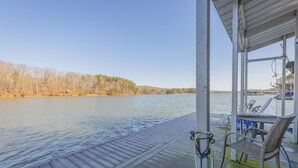 A wooden deck with a view of a calm lake and distant trees. - Hartwell Lake deep water home, family friendly and close to Clemson and UGA (Lavonia)