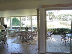 Relax in this open-plan living area with a comfortable seating arrangement and a view of a serene outdoor setting.