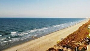 A beach with a clear view of the ocean and a sandy shoreline. - 1-Level Patio Home Great Location 1 Block from Ocean - NO STEPS! w/ 1-car garage (North Myrtle Beach)