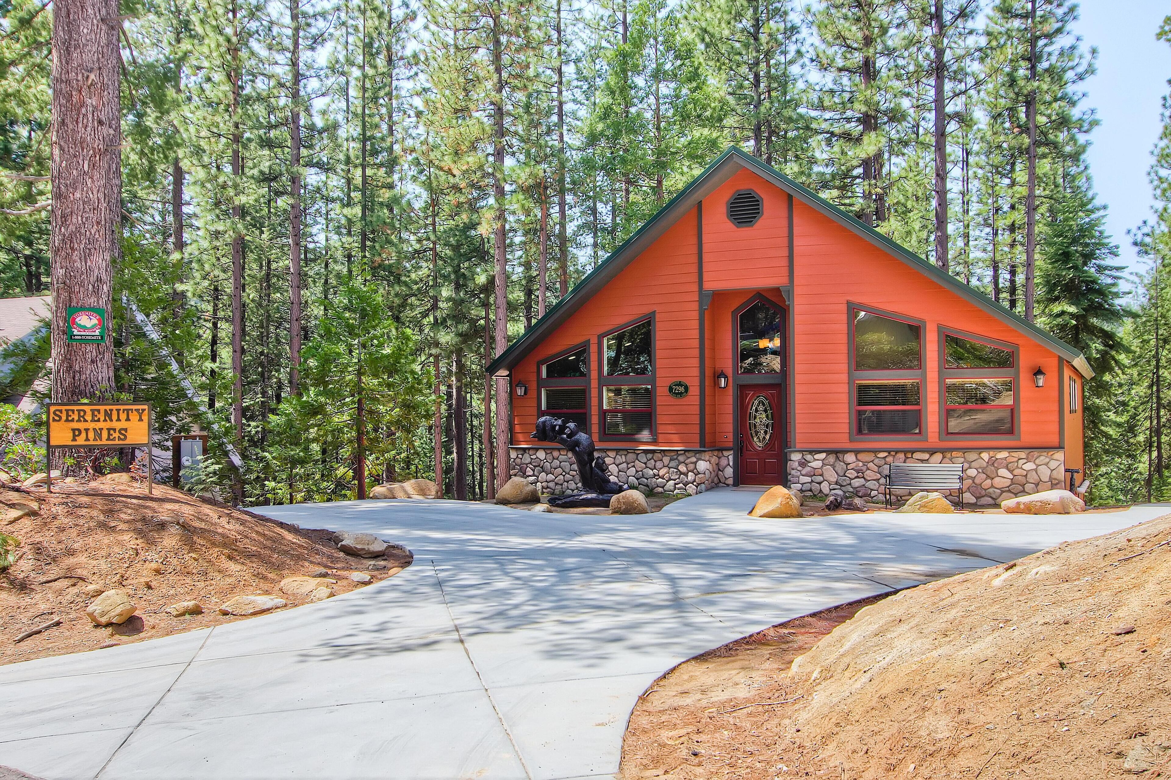 A lodge with a red exterior, stone foundation, and a stone staircase leading to the entrance.