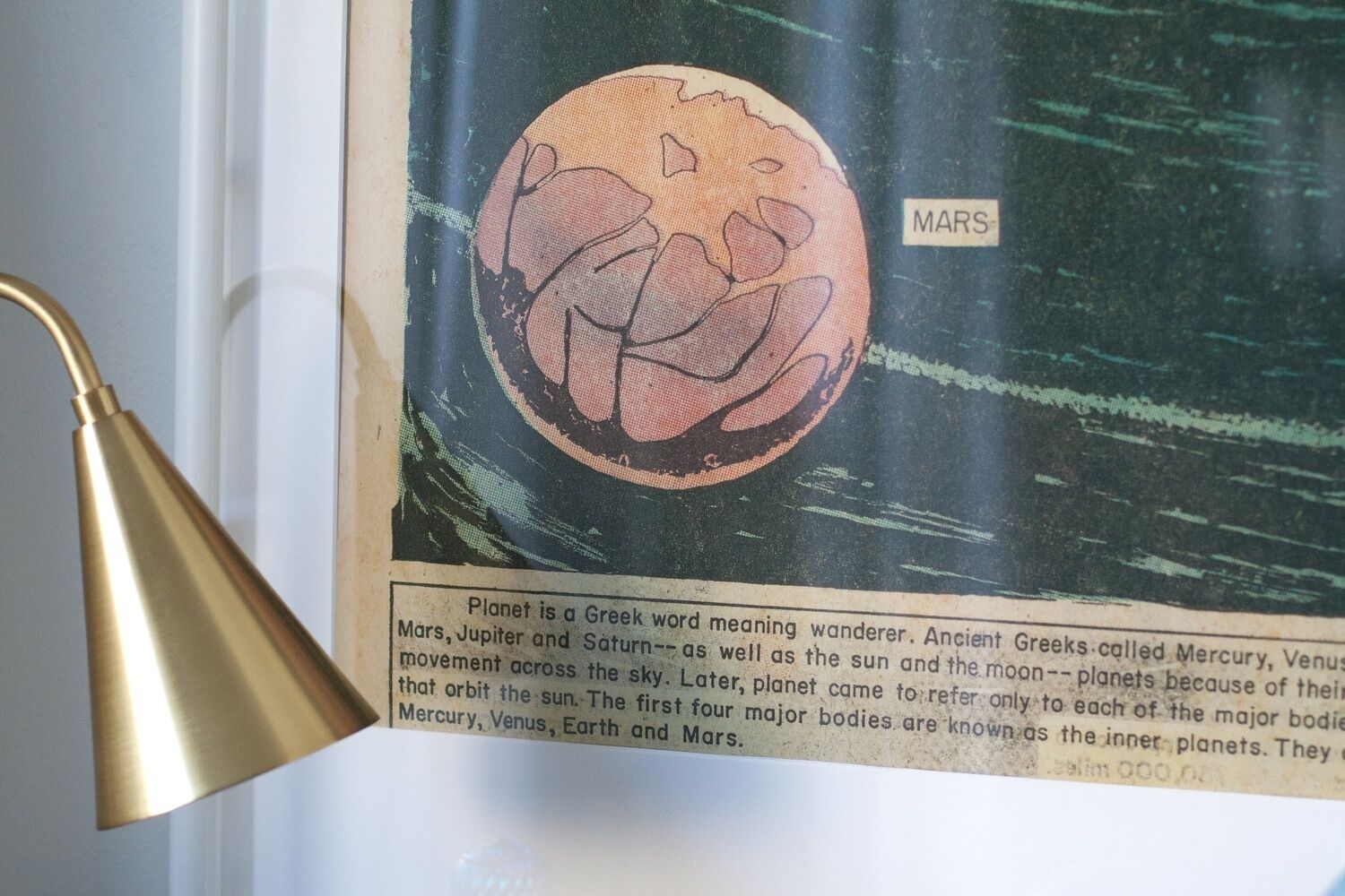 Una ilustración enmarcada de Marte con una leyenda que explica el origen de la palabra 'planeta'.