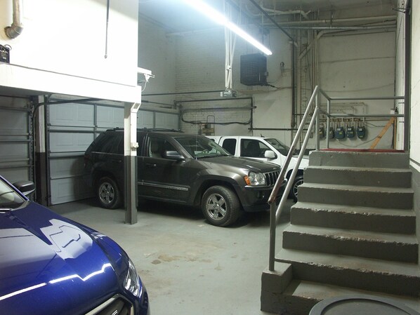 A multi-level parking garage with vehicles parked on both levels.