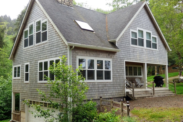 Classic beach house with cedar shake siding on one acre wooded lot.