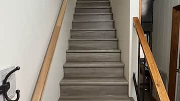 A staircase with wooden handrails and a metal banister.