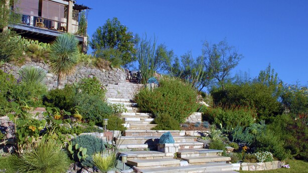 A modern house with a stone staircase leading up to a deck. - Best Sunsets in town! (Marfa)
