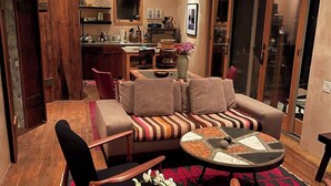 A modern living room with a sofa, chairs, a coffee table, and a kitchen in the background. - Best Sunsets in town! (Marfa)