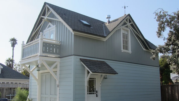 A two-story house with a balcony, a chimney, and a small front porch. - Historic 1887 Carriage House Located On Landmark Property (Santa Cruz)