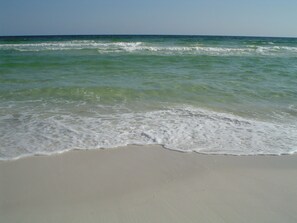 A beach with waves gently lapping onto the shore. - Destin Home Away From Home (Destin)