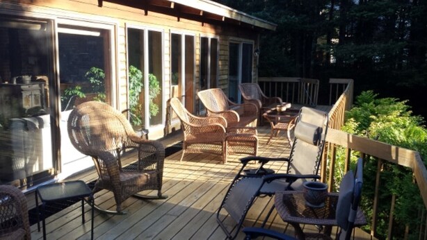 A covered deck with wicker furniture and a glass enclosure. - 1-2 Family Perfection:  Location + Views + Ammenities = Value (West Dover)