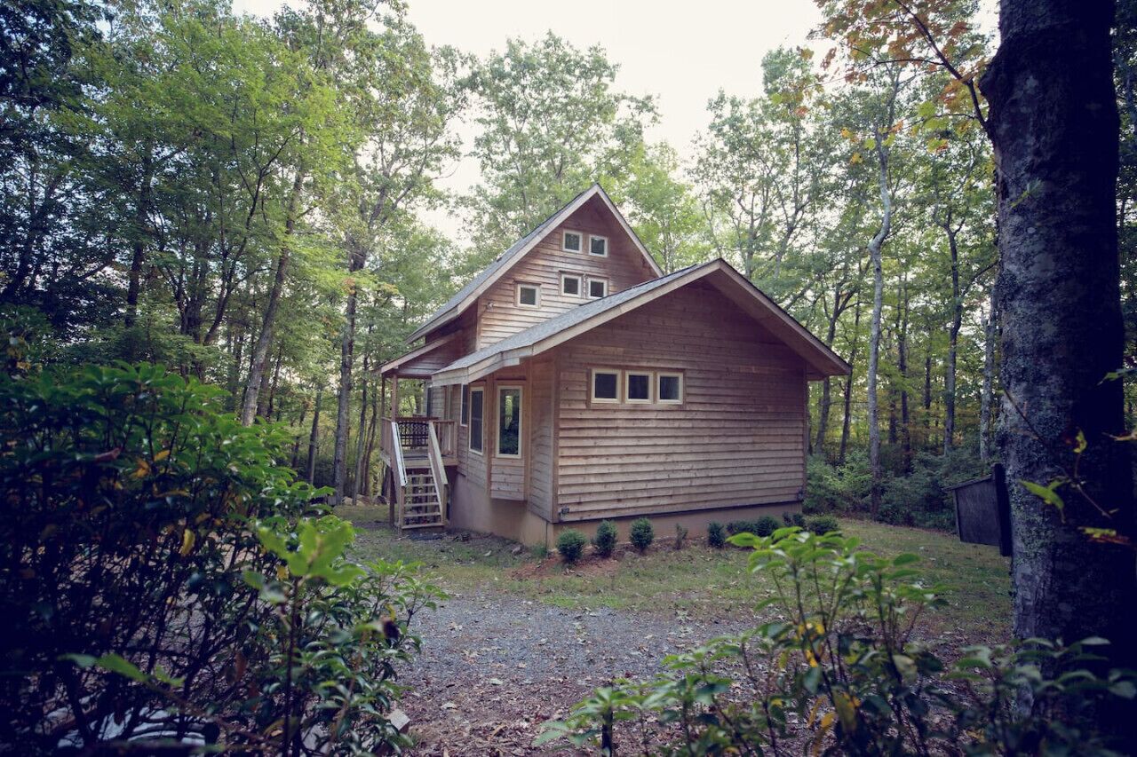 A wooden cabin surrounded by trees.