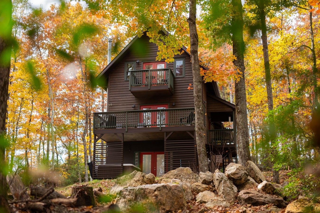 Ridgetop Cabin wrapped in peak fall color, with the forest at its most vivid all around.
