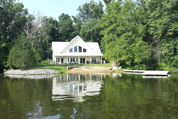 View of house from lake
Beach and boat dock