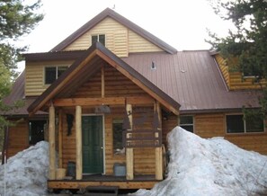 Trinity offers a cozy cabin-style retreat with a gabled roof and inviting front porch.