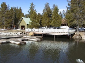 Escape to a serene lakeside retreat surrounded by lush forest and a tranquil water's edge.