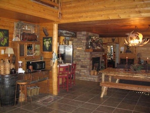 Cozy cabin-style lodging with a stone fireplace, dining area, and self-catering kitchen.