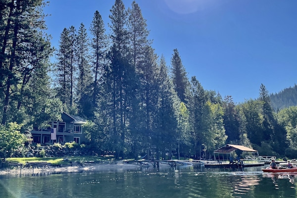 Our home, sandy beach and dock on secluded bay