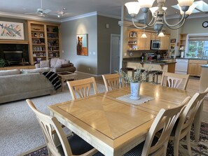 Cozy living and dining space with a comfortable sofa, flat-screen TV, and dining table for six.