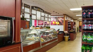 A deli counter with a glass display case filled with various deli items. There are signs above the counter advertising 'Boar's Head' and 'Board's Head' brands. The counter area is adjacent to a beverage shelf stocked with Pepsi and other sodas. - Two-Bedroom Villa at Westgate Vacation Villas Resort just One Mile from DISNEY (Kissimmee)