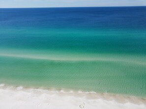 A beach with clear turquoise water and white sand.