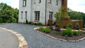A two-story building with a stone facade, multiple windows, and a chimney. - Villa della Luna, an authentic Tuscan Villa in Montaluce, license #3857 (Dahlonega)