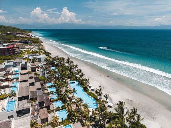 A resort with multiple swimming pools, a beachfront, and a view of the ocean. - Beach Front Condo w/ Balcony! Amazing Views, White Sand & Pools! (Punta Mita)