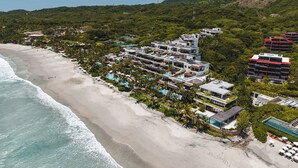A coastal hotel with multiple buildings, a beach, and a pool area. - Beach Front Condo w/ Balcony! Amazing Views, White Sand & Pools! (Punta Mita)