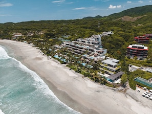 A coastal hotel with multiple buildings, a beach, and a pool area. - Beach Front Condo w/ Balcony! Amazing Views, White Sand & Pools! (Punta Mita)