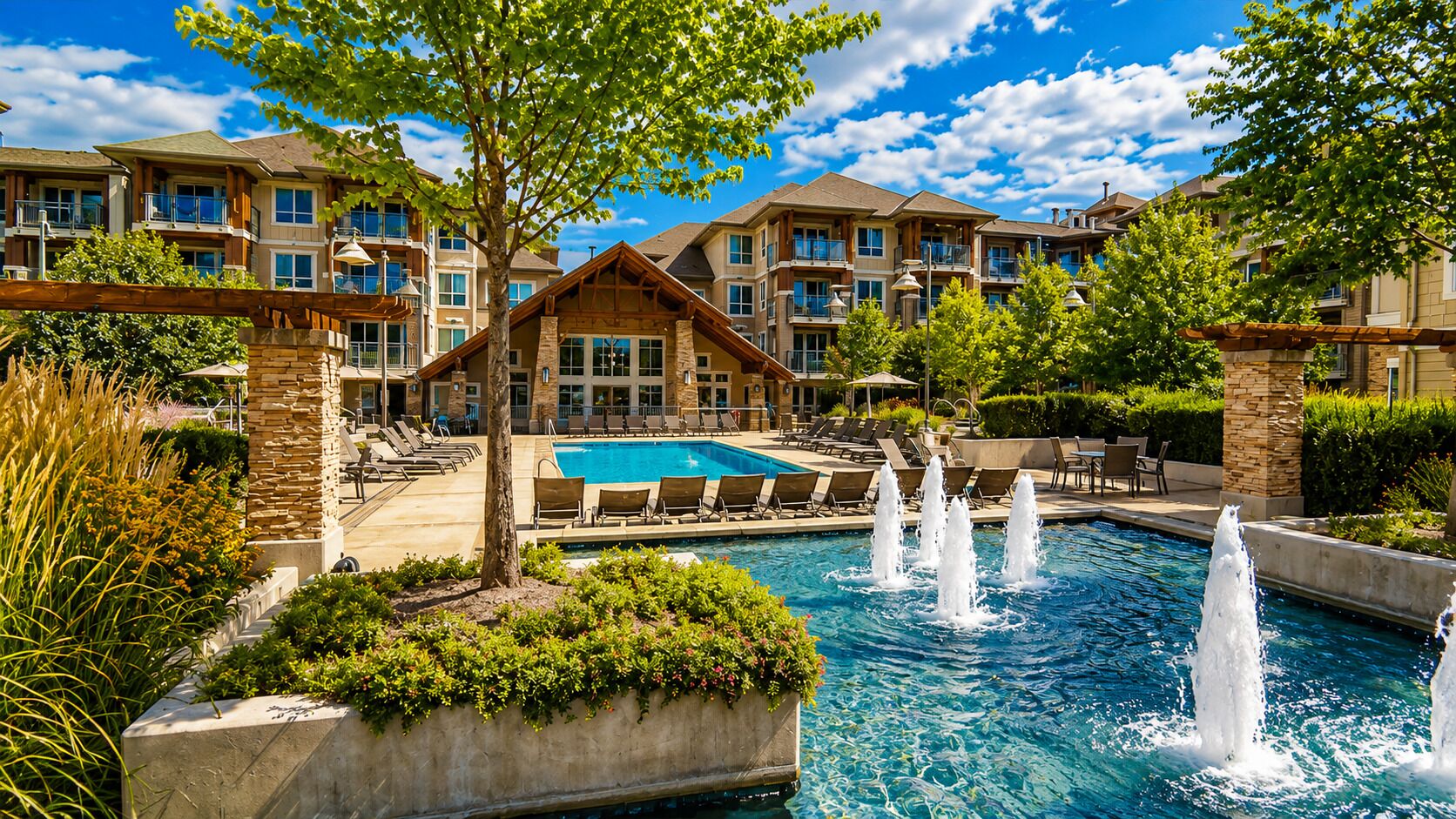 A hotel with a swimming pool, multiple balconies, and a landscaped garden area.