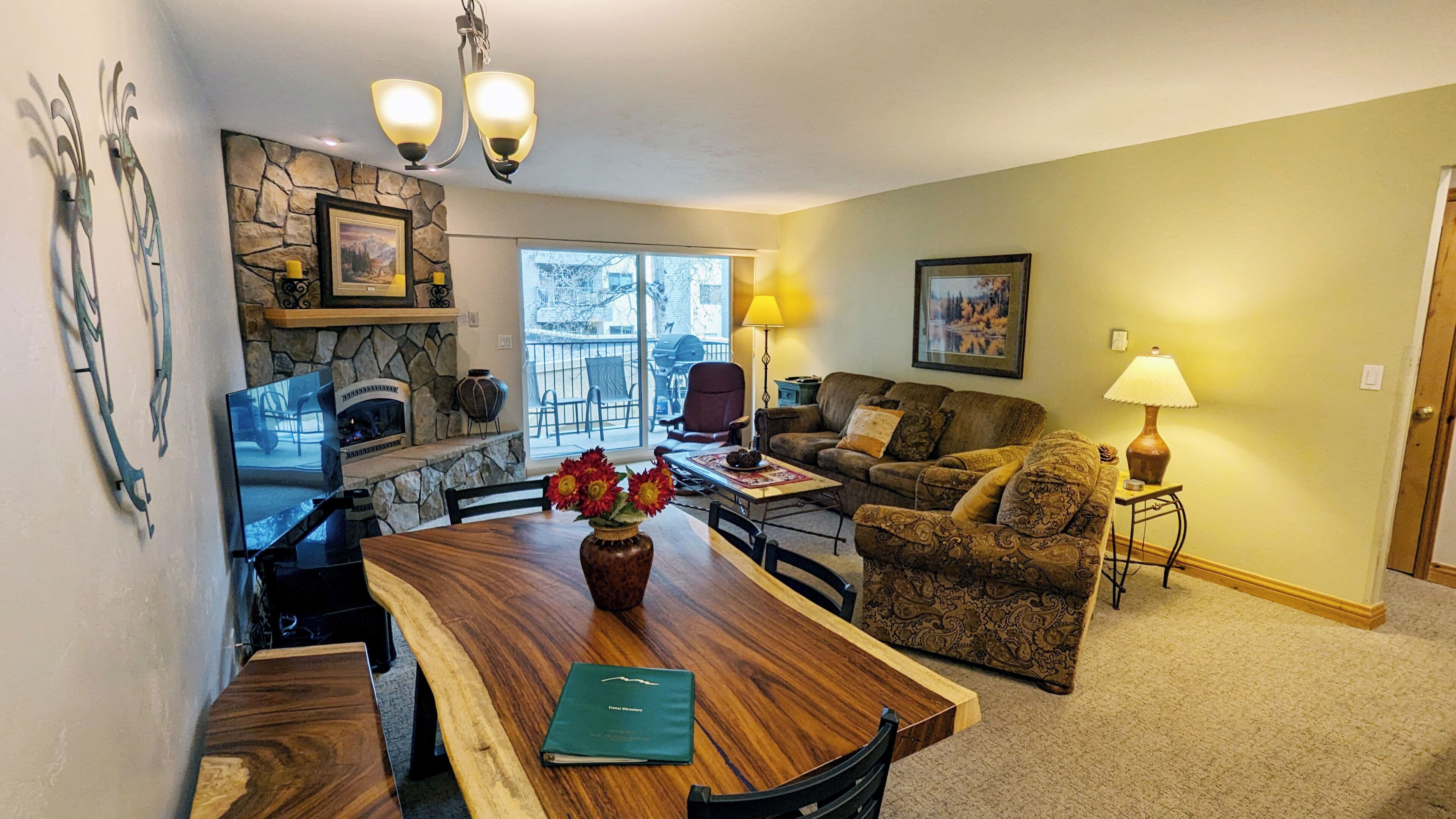 Living room with sofa bed, gas fireplace, and balcony w/ propane BBQ grill