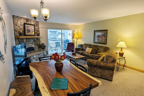 Living room with sofa bed, gas fireplace, and balcony w/ propane BBQ grill