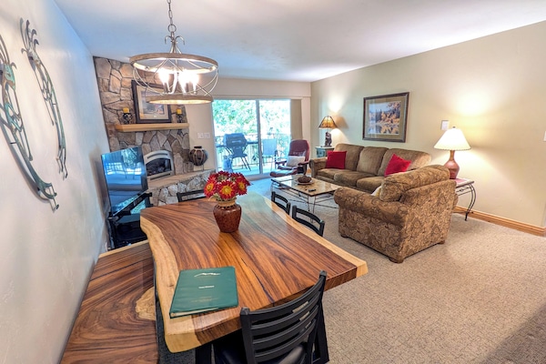 Living room with sofa bed, gas fireplace, and balcony w/ propane BBQ grill