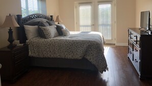 A bedroom with a bed, nightstands, a dresser, a ceiling fan, and a window with blinds. - Great location!! Pool! Unit 5201- Mtn. View Condos, 3 Bed, 2 Bath (Pigeon Forge)