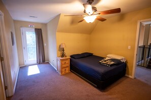 A bedroom with a bed, a nightstand, a ceiling fan, and a door with a window. - This home has it all and more!! Message me for video tour! (Lakehead)