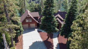 A two-story house with a red exterior, a garage, and a driveway leading to the front door. - This home has it all and more!! Message me for video tour! (Lakehead)