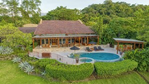 A house with a swimming pool, covered patio, and lush garden. - Welcome to Casa Caiman | FULL STAFFED + 2 BOATS by Viridian Experience (peninsula papagayo)