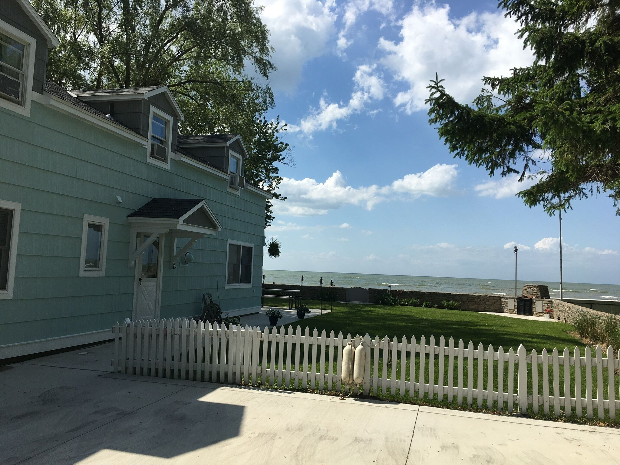 Lake Front Nautical Themed Home with Private Yard & Sandy Bottom Water Access!