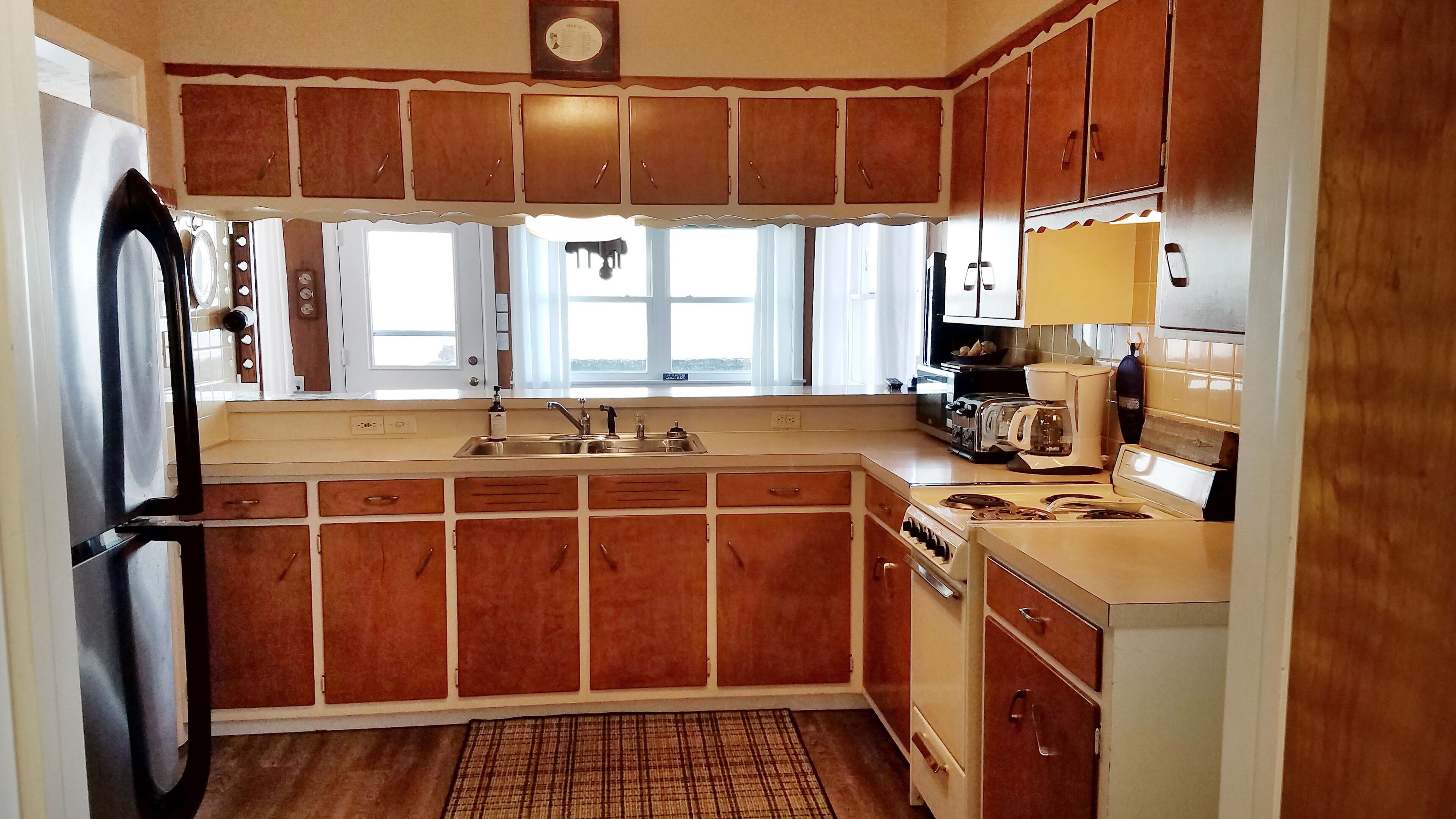 Lake Front Nautical Themed Home with Private Yard & Sandy Bottom Water Access!