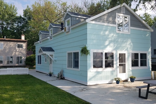 Large patio and walkway, front door and side door access to the yard.