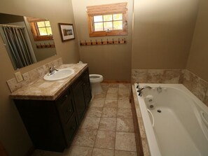 A bathroom with a sink, toilet, and bathtub.