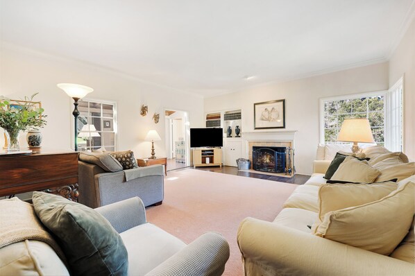 A spacious living room with a fireplace, a television, and a comfortable seating area. - Stunning 5 Acre Carmel Retreat, 2 Hot Tubs, Amazing Location! (Carmel)