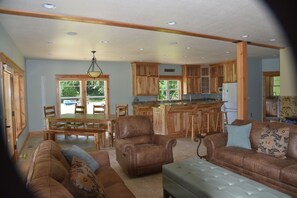 Relax in this inviting living area with a sofa set, armchair, and ottoman.