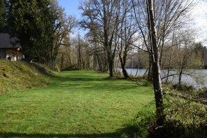 Escape to a serene lakeside retreat with a tranquil pathway leading to the water's edge.