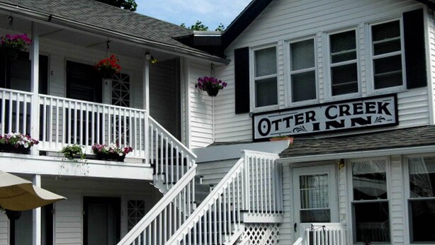 A two-story building with a balcony and a sign that reads "Otter Creek Inn". - Room 3 at Otter Creek Inn (Mt Desert)
