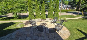 A patio area with a fire pit and seating.