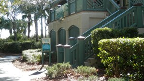A building with a green staircase and a signboard.