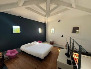 A bedroom with a bed, a desk, a chair, and a window. - Stunning and spacious home in Provence!  (Lourmarin)