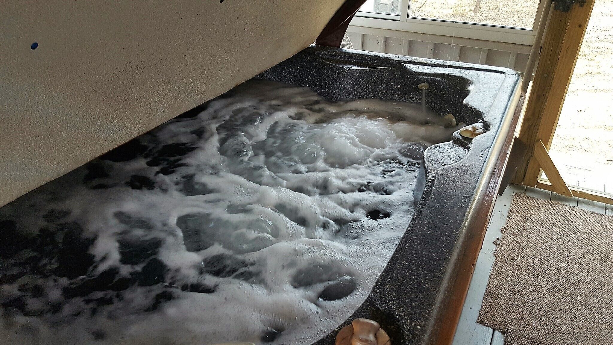 A bathtub filled with water and bubbles.